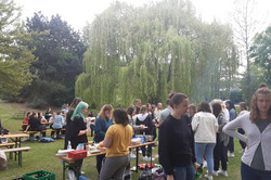 Mitten im Grünen (auf der Wiese vor der EF50) stehen viele Menschen um einen Grill. Das kann nur bedeuten, dass die Fachschaft ihr berühmtes Fachschafts- bzw. Fakultätsgrillen veranstaltet. Bei Bier und Softgetränken, sowie allerlei leckerer Nahrungsmittel sind die Studierenden sitzend oder stehend in Gespräche vertieft.